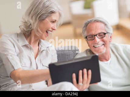 Senior couple using digital tablet at home Stock Photo