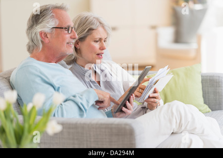 Senior couple paying bills via internet Stock Photo
