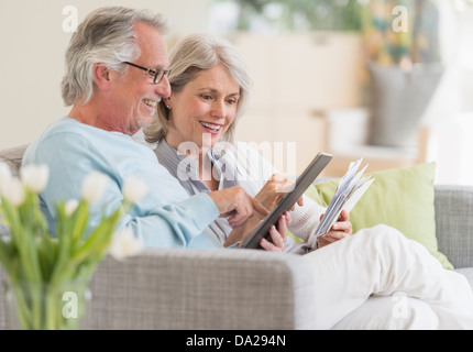 Senior couple paying bills via internet Stock Photo