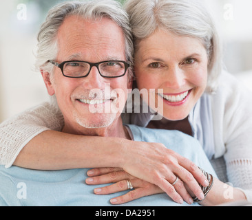 Senior woman embracing senior man Stock Photo