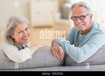 Senior couple sitting on sofa Stock Photo