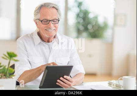 Senior man using digital tablet Stock Photo