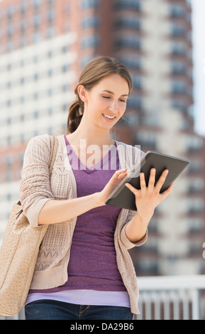 Young female using digital tablet Stock Photo
