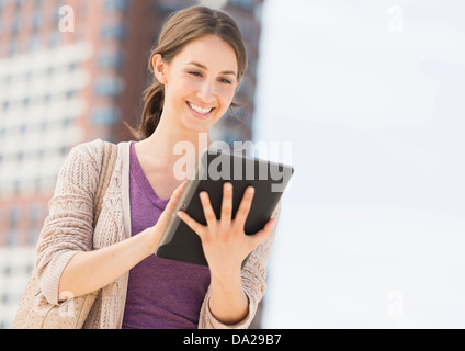Young female using digital tablet Stock Photo