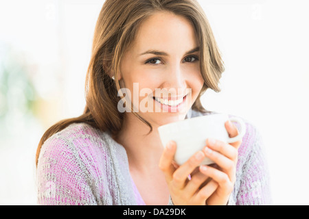 Portrait of young woman drinking tea Stock Photo