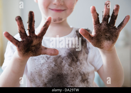 Boy (4-5) showing dirty hands Stock Photo