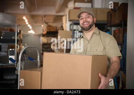 Portrait of delivery man in warehouse Stock Photo