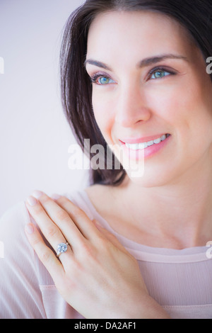 Portrait of smiling woman with engagement ring Stock Photo