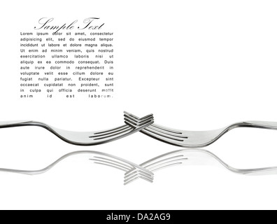 Two interlaced silver forks with reflection isolated on white with sample text. Stock Photo