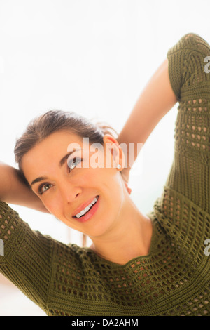 Woman with hands behind head Stock Photo