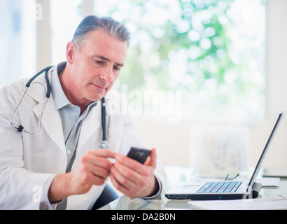 Portrait of doctor using mobile phone Stock Photo