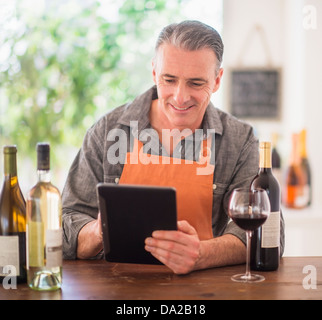 Portrait of restaurant owner using digital tablet Stock Photo