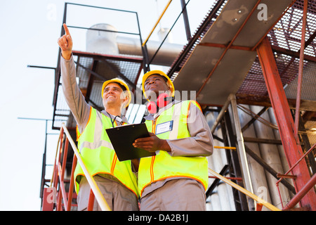 two workers working at petrochemical plant Stock Photo