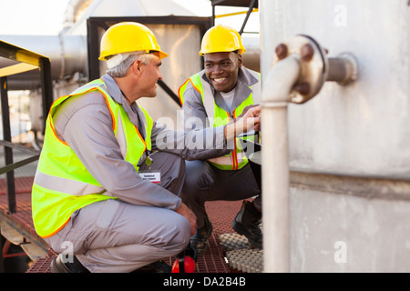 two oil chemical industry technicians working in plant Stock Photo