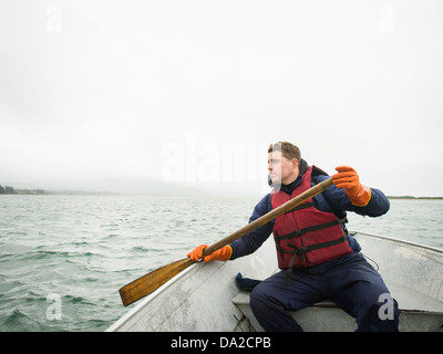 USA, Oregon, Rockaway Beach, Portrait of young man paddling boat Stock Photo