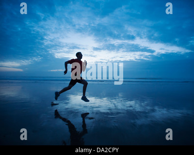 USA, Oregon, Rockaway Beach, Man running along beach Stock Photo