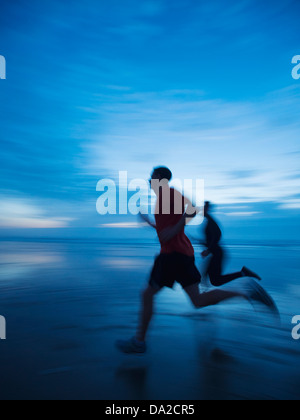 USA, Oregon, Rockaway Beach, Man running along beach Stock Photo