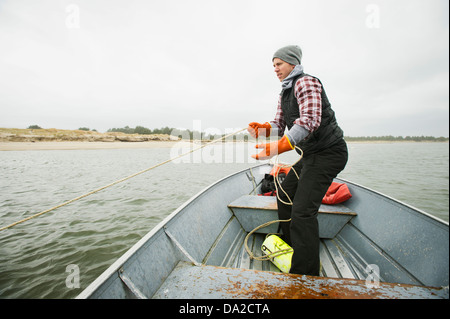 USA, Oregon, Rockaway Beach, Man pulling net full of crabs Stock Photo