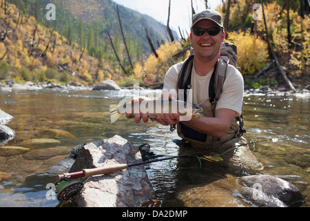 USA, Montana, North Fork, Blackfoot River, Fisherman showing fresh trout Stock Photo