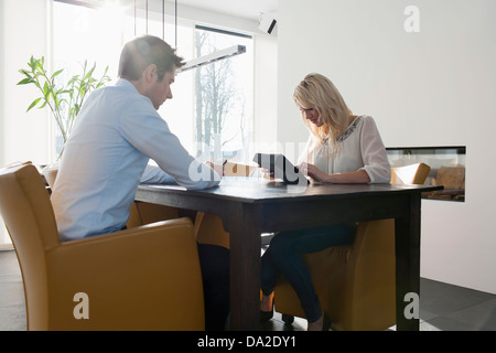 Couple sitting at table in morning Stock Photo