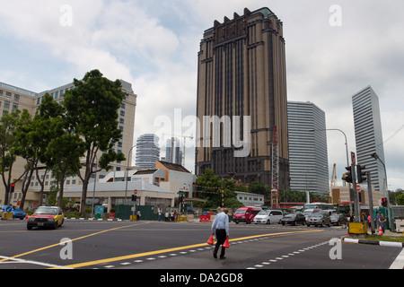 Man crossing a road/street near Parkview Square office building, Singapore Stock Photo