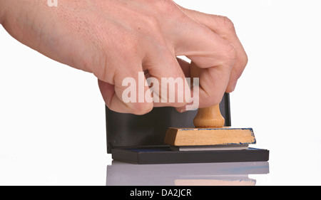 Hand with wooden stamp isolated on white background Stock Photo