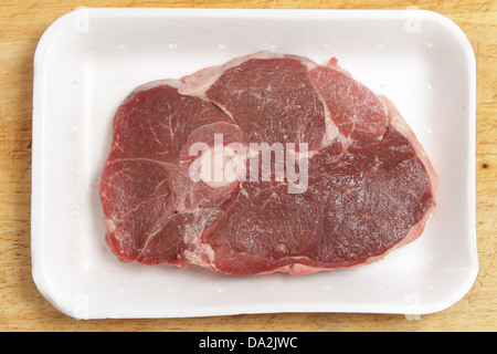 A lamb's leg chop or steak on a supermarket polystyrene tray Stock Photo