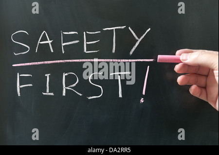Safety first words written on blackboard Stock Photo