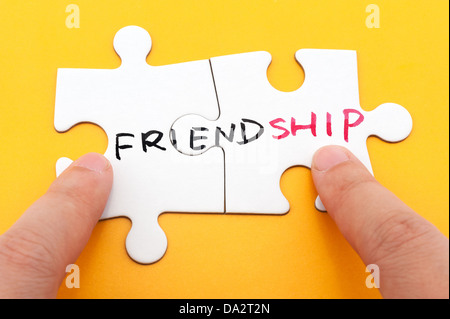 Friendship word written on two pieces of puzzle Stock Photo