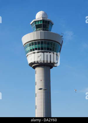 The air traffic control tower of AMS Schiphol airport Amsterdam, the Netherlands against a blue sky