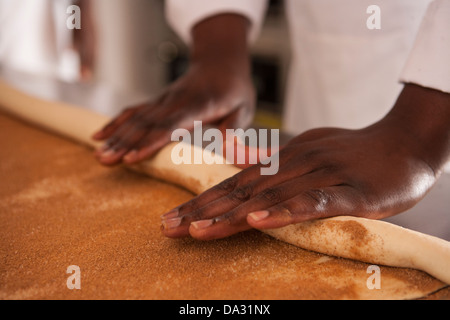african american women making cinnamon buns from scratch Stock Photo