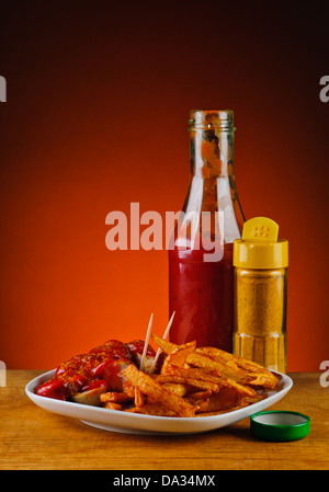 curry sausages or currywurst with french fries and ketchup sauce Stock Photo