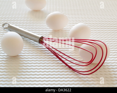 Still Life of Eggs and Flat Wire Whisk Stock Photo