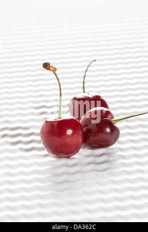 Three Cherries on White Background Stock Photo