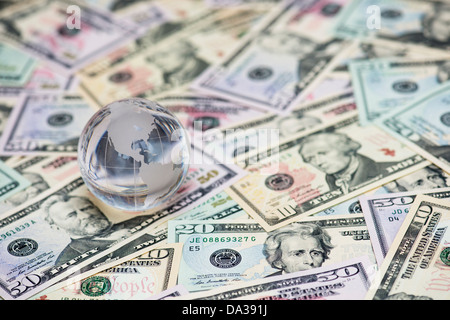 Glass Globe showing America on American dollar bills Stock Photo