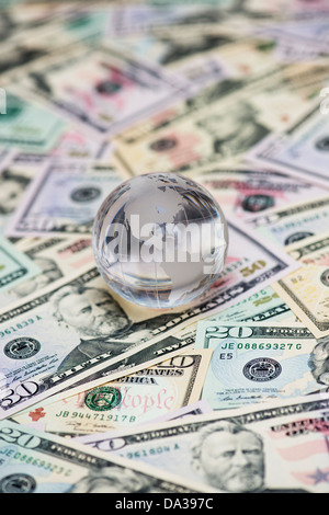 Glass Globe showing America on American dollar bills Stock Photo