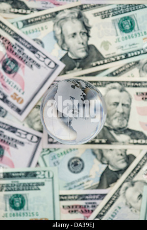 Glass Globe showing America on American dollar bills Stock Photo