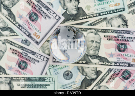 Glass Globe showing America on American dollar bills Stock Photo