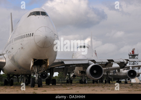 A group of retired jet airline planes stored and having had items removed. Often referred to as a boneyard, scrapping likely Stock Photo