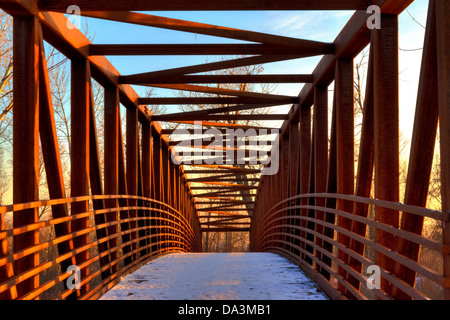Symmetrical view of footbridge over Boise River in downtown Eagle, Idaho, on winter evening Stock Photo