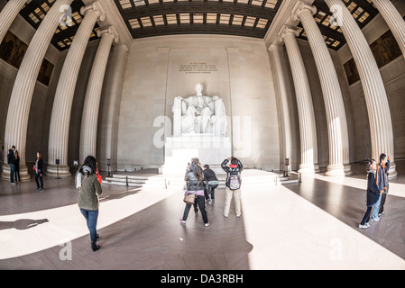 WASHINGTON DC, USA - Tourists visit the statue of Abraham Lincoln at the Lincoln Memorial in Washington DC. Wide-angle fisheye lens. Stock Photo