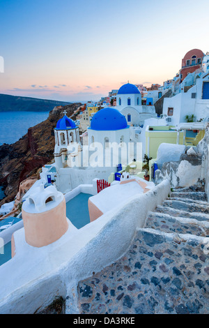 Dusk over blue domed churches at Oia Santorini Greece Stock Photo