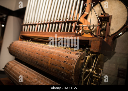 BRUSSELS, Belgium — A hybrid instrument combining elements of a pianola and a pipe organ on display at the Musical Instrument Museum in Brussels. This unique musical device showcases innovative instrument design, blending automated piano technology with traditional organ pipes. Stock Photo