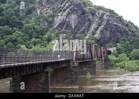 HARPERS FERRY, West Virginia, United States — A historic railroad bridge carries CSX railway tracks across the Potomac River from Harpers Ferry, West Virginia, into Maryland. The bridge, an integral part of Harpers Ferry National Historical Park, represents the continued importance of rail transportation in this scenic and historically significant location where the Potomac and Shenandoah rivers meet. Stock Photo