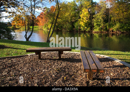Wooden Park Benches Overlooking A Fishing Lake In Autumn, Southwestern Ohio, USA Stock Photo