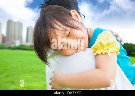 smiling little girl sleeping on his father shoulder Stock Photo