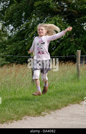 young girl jumping happily Stock Photo