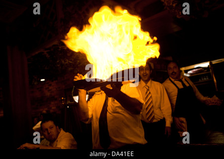 A waiter hold a Flaming Greek Cheese at Pegasus restaurant in the Detroit district of Greektown Stock Photo