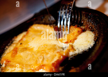 A flaming Greek Cheese at Pegasus restaurant in the Detroit district of Greektown Stock Photo