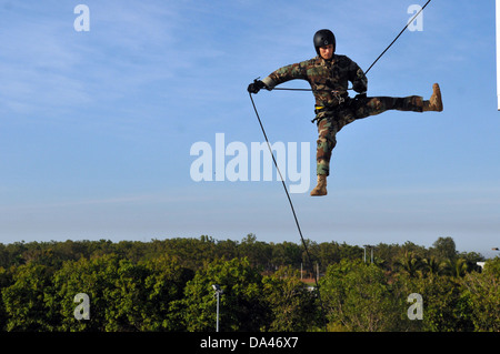 US Navy Lt. Ryan Ramsden with the Explosive Ordnance Disposal Mobile Unit rappels off a tower while training with members of the Australian Northern Territory Tactical Response Group July 20, 2011 in Darwin, Australia. Stock Photo